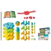 A collection of colorful building blocks and accessories, along with two booklets, laid out on a white background. Voir les images du produit