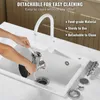 A person is cleaning a meat grinder in a sink under running water. Podgląd zdjęcia produktu