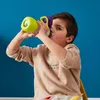A young boy drinks from a colorful sippy cup. Produktbild-Vorschau