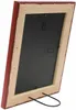 The back of a red wooden picture frame with a black backing and a metal stand. Voir les images du produit