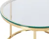 A close-up shot of the edge of a round glass-top coffee table with a gold metal frame. Náhľad obrázku produktu