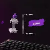 An exploded view of a keyboard switch with measurement indicators and a purple paint splash. Voir les images du produit