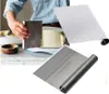 A person is using a metal scraper to frost a cake, with other baking tools visible. Produktbild-Vorschau
