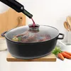 A roast duck is being cooked in a large oval pot with a glass lid, and red wine is being poured into it from a bottle. Náhled obrázku produktu