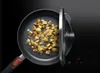 A frying pan with potatoes cooking on a stovetop. Produktbild-Vorschau