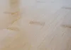 A close-up, angled view of a light-colored wooden surface, likely bamboo, showing the grain and texture. Náhľad obrázku produktu