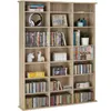 A light brown wooden bookshelf filled with DVDs, CDs, books, and decorative items. Náhled obrázku produktu