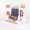The image shows the packaging of an electric grill, with a picture of the grill and food on it, as well as a woman holding a cup. Produktbild-Vorschau
