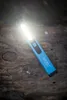 A blue HAZET LED pen light is lying on a textured wooden surface. Náhled obrázku produktu