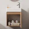 A modern bathroom vanity with a white sink and a wooden cabinet, featuring rolled towels and a soap dispenser inside. Produktbild-Vorschau