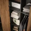 Interior view of a wardrobe with shelves and hanging clothes. Anteprima dell’immagine prodotto