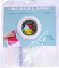 Product packaging for laundry bags, showing a hand putting clothes into a washing machine and the bags themselves. Voir les images du produit