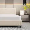 A close-up view of a mattress on a bed frame in a bedroom setting. Produktbild-Vorschau