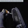 A gloved hand is applying oil to the chain and bar of a small chainsaw. Voir les images du produit