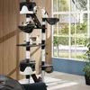 A multi-level cat tree with several cats playing on it, placed in a living room setting near a large window. Náhled obrázku produktu