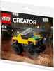 A polybag containing a LEGO Creator monster truck set, displayed against a background of stadium seating and lights. Produktbild-Vorschau