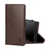 A dark brown leather phone case with a built-in stand is shown open, revealing a black smartphone inside. The case has a subtle embossed logo of a bull's head on the front cover. Anteprima dell’immagine prodotto