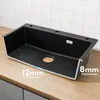 A black kitchen sink is shown on a wooden countertop with a tiled backsplash. Produktbild-Vorschau
