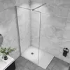 A modern walk-in shower enclosure with a glass panel and a white shower tray, set against marble-effect tiles. Produktbild-Vorschau