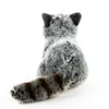 A plush toy raccoon seen from the back, with its tail extended. Produktbild-Vorschau