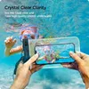 Two children are underwater, one holding a smartphone in a waterproof case, taking a picture of the other child. Náhľad obrázku produktu