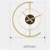 A modern wall clock with a gold frame and a white, textured face. Produktbild-Vorschau