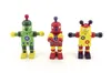 Three wooden robot toys are standing on a white background. Voir les images du produit