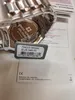 A close-up of a watch with its price tag and some accompanying documentation. Náhľad obrázku produktu