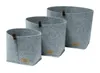 Three grey felt baskets of varying sizes are arranged diagonally on a white background. Produktbild-Vorschau