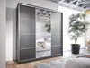 A modern bedroom with a large sliding door wardrobe with mirrored panels. Náhled obrázku produktu