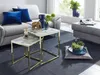 A living room scene with a sofa, coffee table, and ottoman. Produktbild-Vorschau