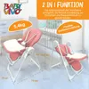Two pink high chairs are shown in a room with a crib in the background. One chair is in the foreground, and the other is in the midground. Produktbild-Vorschau