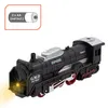A toy train set with a locomotive and a lit headlight, presented on a white background. Produktbild-Vorschau