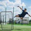 A man is practicing soccer with a rebounder net on a sunny day. Náhled obrázku produktu