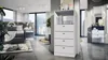 A modern bedroom with a dresser and a bed. Produktbild-Vorschau