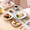 A table setting with plates of food, a cup of coffee, and a cupcake. Náhled obrázku produktu