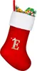 A red Christmas stocking filled with gifts and greenery. Podgląd zdjęcia produktu