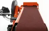 Close-up view of an orange and brown belt sander on a white background. Voir les images du produit