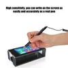 A hand is holding a stylus and touching a small screen on a black stand. Podgląd zdjęcia produktu
