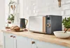 A modern kitchen counter with a microwave, bread, and soup. Náhled obrázku produktu