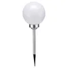 A single solar garden light with a spherical white top and a silver pole with a pointed end.