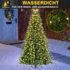 A Christmas tree decorated with lights, set up outdoors in the rain. Produktbild-Vorschau
