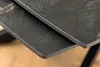 Close-up of the edge of two stacked tabletops with a marbled pattern. Produktbild-Vorschau
