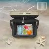 A cooler box filled with food and drinks on a sandy beach with the ocean in the background. Anteprima dell’immagine prodotto