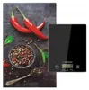 A kitchen scale is placed next to a decorative arrangement of red chili peppers and peppercorns. Náhľad obrázku produktu