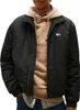 A man wearing a black jacket over a tan hoodie and a checkered shirt. Voir les images du produit