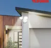 A white LED outdoor light with motion sensor is mounted on the exterior wall of a modern house. Produktbild-Vorschau