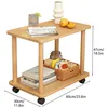 A two-tiered wooden side table with wheels, displaying various items on its surfaces. Produktbild-Vorschau