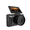 A black digital camera with its screen flipped up, displaying a sunset scene with people. Produktbild-Vorschau