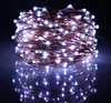 A close-up shot of a coiled string of white LED lights with copper wire, reflected on a dark surface. Produktbild-Vorschau